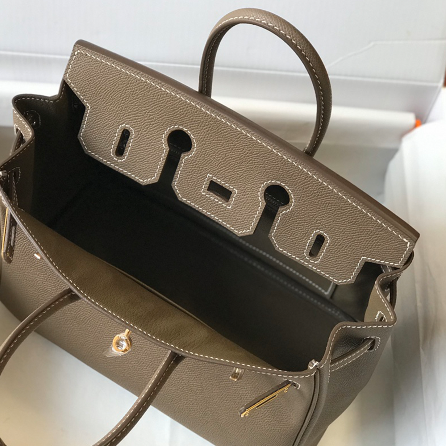Muted Elephant Grey Fine Crosshatch Grain Structured Hand Tote With Contrast Light Stitching, Polished Golden Twist Lock Hardware And Dual Curved Top Carry Grips