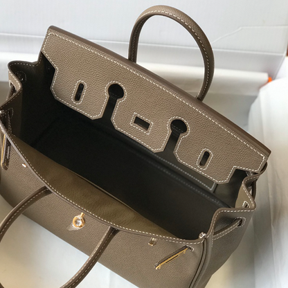 Muted Elephant Grey Fine Crosshatch Grain Structured Hand Tote With Contrast Light Stitching, Polished Golden Twist Lock Hardware And Dual Curved Top Carry Grips